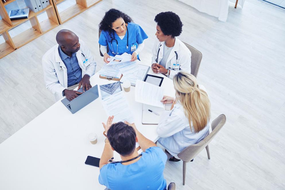 Healthcare and meeting by doctors on laptop for research, planning and innovation at hospital.