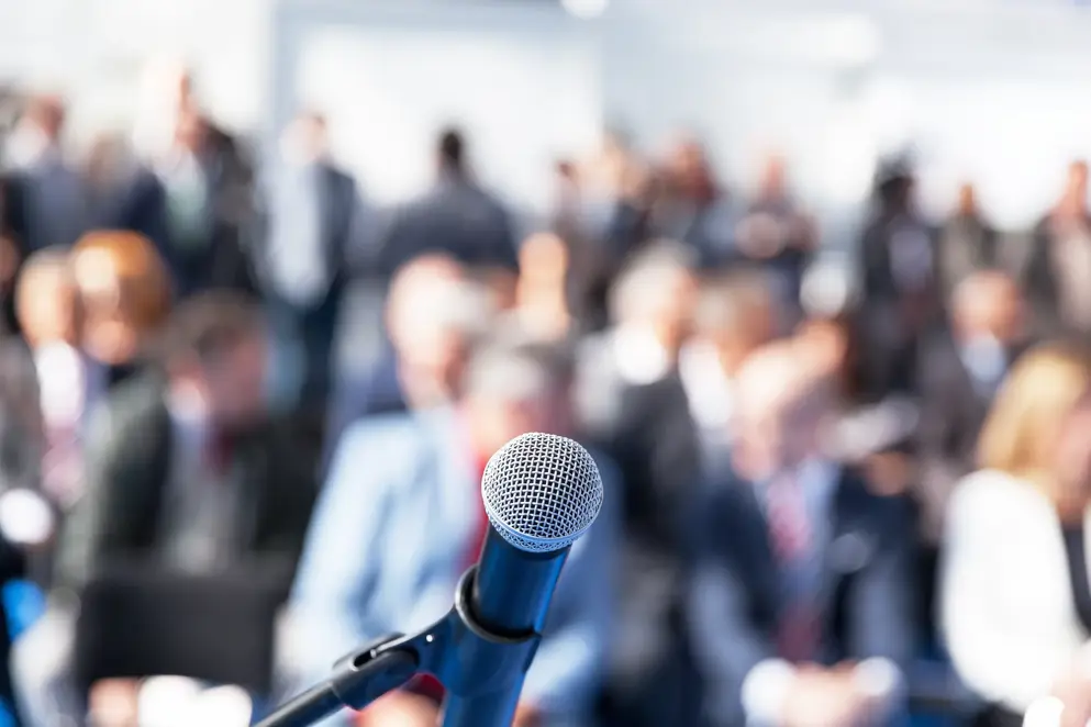 Auditorium of people and microphone.