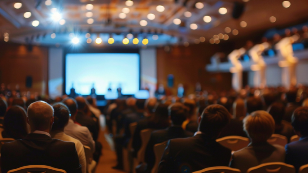 Auditorium of people attending a symposium.